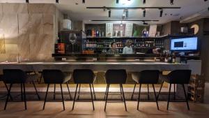 a bar in a restaurant with people behind a counter at International Citizen Hotel in Kaohsiung