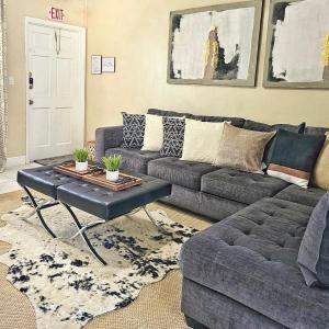 a living room with a couch and a coffee table at Glam 2 Bedroom Apartment Close to NSU in Cooper City in Cooper City