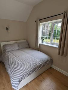 a bed in a bedroom with a window at The Annexe at Entry House in Quadring