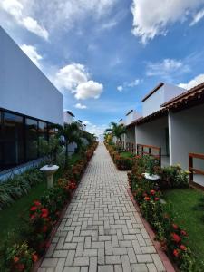 a walkway leading to a building with flowers at Hotel Reserva do Xingó in Piranhas