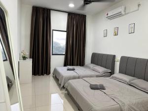 a bedroom with two beds and a window at Inadh Suites @ Icon Residence With Pool in Kuala Terengganu +24 photos