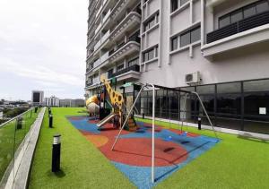 a playground in front of a building at Inadh Suites @ Icon Residence With Pool in Kuala Terengganu