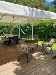 a patio with a table and chairs under a white umbrella at Mobil home Parc Montana in Gassin