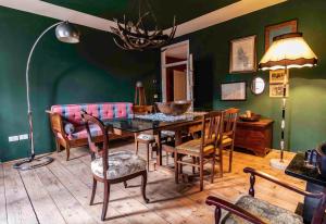a dining room with a table and chairs and a couch at La Maisonette in Feltre