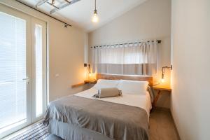 a bedroom with a bed with two pillows and a window at Agriturismo Sweet Cottage in Marina di Grosseto