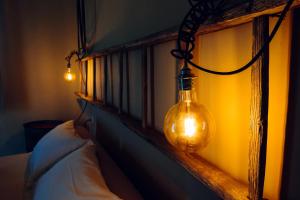 a bedroom with a bed with two lights on it at Agriturismo Sweet Cottage in Marina di Grosseto