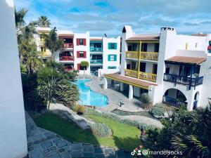 an aerial view of a resort with a swimming pool at Mandy's kaliva Club Mykonos in Langebaan
