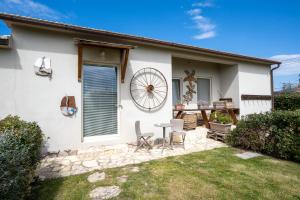 a house with a patio and a table and chairs at Agriturismo Sweet Cottage in Marina di Grosseto