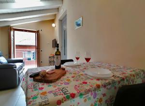 a table with two glasses and a bottle of wine at La Stalletta in Menaggio