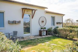 a white house with a window and a yard at Agriturismo Sweet Cottage in Marina di Grosseto