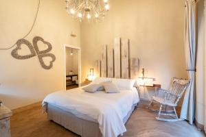 a bedroom with a bed and a chandelier at Agriturismo Sweet Cottage in Marina di Grosseto +37 photos