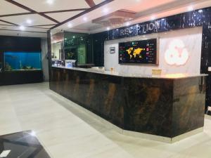 a bar in a restaurant with a counter top at Pool & Park Hotel in Lahore