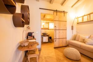 a living room with a couch and a table at Agriturismo Sweet Cottage in Marina di Grosseto