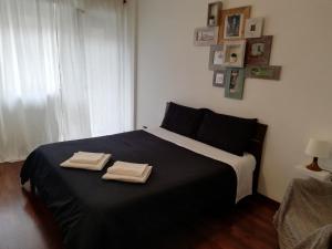 a bedroom with a bed with two towels on it at De Rossi Holiday in Bari