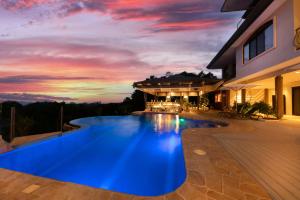 a swimming pool in the middle of a house at Marala Hotel in Esterillos