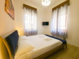 a bedroom with a bed with white sheets and a window at Italianflat - Rentroom Verona in Verona