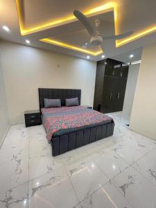 a bedroom with a bed and a ceiling fan at Bahria Residency 1 in Islamabad