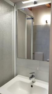 a bathroom with a sink and a mirror at Mansarda al mare in Pertegada