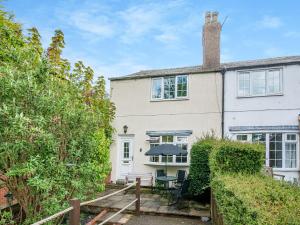 an exterior view of a house with a wooden walkway at Lilac Cottage in Grosmont