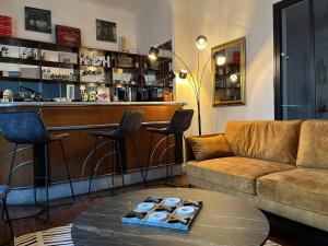 a living room with a couch and a bar at La Maison de Louisette in Le Faouët