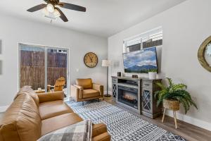 a living room with a couch and a tv at Serene Escape - Close to Sedona and Grand Canyon in Flagstaff