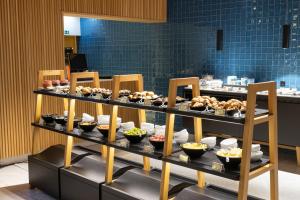 a buffet of food on display in a restaurant at Evora Olive Hotel in Évora