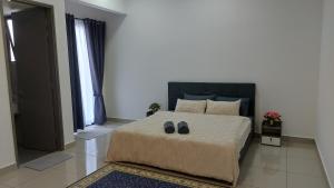 a bedroom with a bed with a pair of shoes on it at TL145 The Strata in Kajang