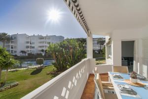 una sala da pranzo con tavolo e sedie sul balcone di MARBELLA BANUS SUITES - Banus Playa Rocio Beachfront Complex a Marbella