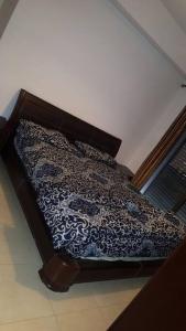 a bed with a blue and white blanket on it at شقه مفروشه سوبر ديلوكس in Amman
