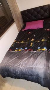 a bed in a room with a black bed frame at شقه مفروشه سوبر ديلوكس in Amman