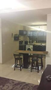 a kitchen with a table and chairs in a room at شقه مفروشه سوبر ديلوكس in Amman