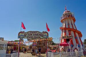 a carnival with a ferris wheel and a ride at Lovely Caravan With Large Decking At Southview Holiday Park Ref 33108s in Skegness