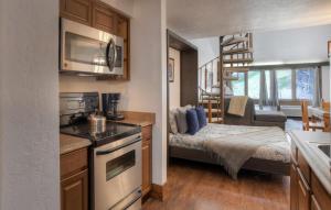 a small kitchen with a bed in a tiny house at Tamarron Lodge Loft 338 in Durango