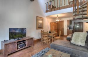 a living room with a couch and a dining room at Tamarron Lodge Loft 338 in Durango