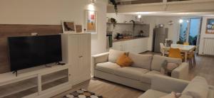 a living room with a couch and a flat screen tv at CaSaMaS Spacious 75m Apartment in Brindisi Historic Center Rated 9 in Brindisi