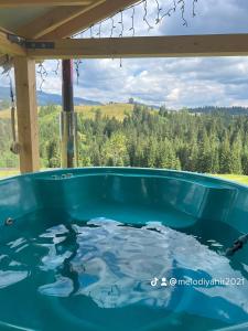 a jacuzzi tub with a view of the mountains at Мелодія Гір .Апартаменти з видом на гори . in Vorokhta