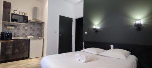 a bedroom with a bed with two towels on it at Guest Home location in Néris-les-Bains