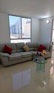 sala de estar con sofá y mesa de cristal en Apartamento amoblado NUEVO frente sede selección Colombia, en Barranquilla