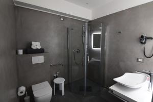 a bathroom with a shower and a toilet and a sink at Hotel Fiume in Genoa