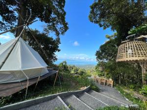 a bell tent with a view of the ocean at The Hidden Gem in Ban Nok