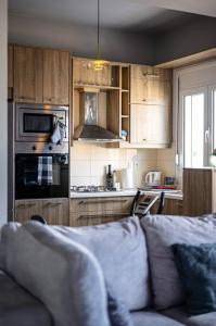 a living room with a couch and a kitchen at MegaLuxe Apartment in Heraklio Town