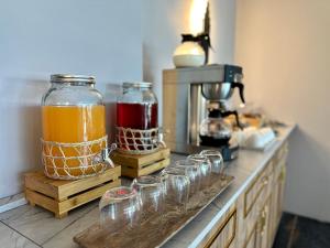 a counter with a row of glass jars on a kitchen counter at Skymoon Istanbul Airport Hotel in Arnavutköy