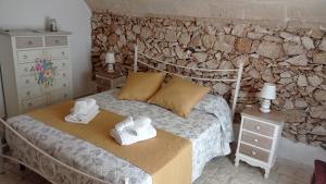 a bedroom with a bed with towels on it at Le Pajare B&b in Sava +39 photos