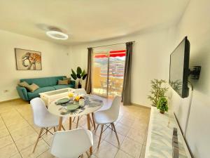 a living room with a table and chairs at Sea Garden in Puerto de Santiago