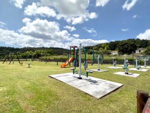 a park with a bunch of swings and slides at Apartamentos Naturmar in Raxó