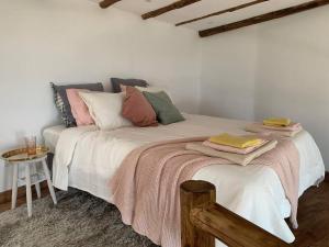 a bedroom with a bed with pillows and a table at Romantic eco retreat in Adeje