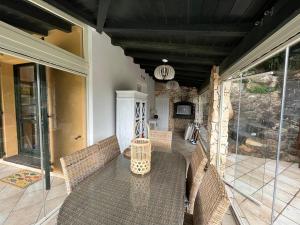 a patio with wicker chairs and a table on a house at Villa Giglio in Torre delle Stelle