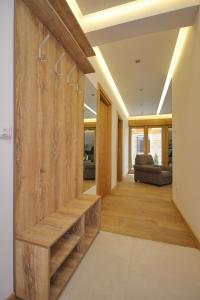 a hallway of a house with a wooden wall at Apartman Giron in Zlatibor