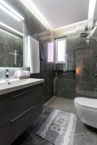 a bathroom with a sink and a tub and a toilet at Delis Villa in Kato Gouves