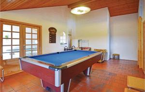 a living room with a pool table in it at 5 Bedroom Stunning Home In ster Assels in Ljørslev